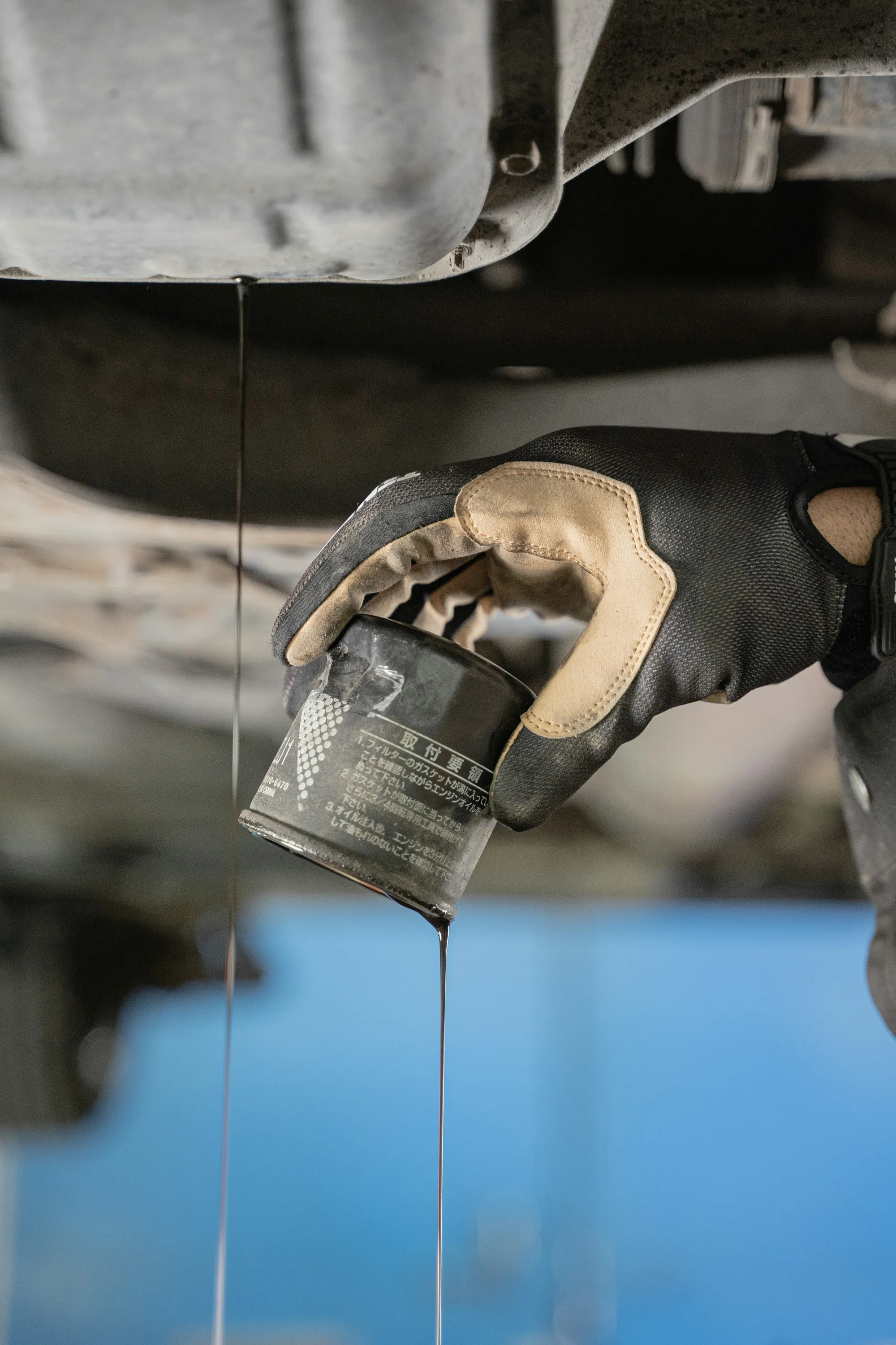 Golden motor oil dripping from an oil filler