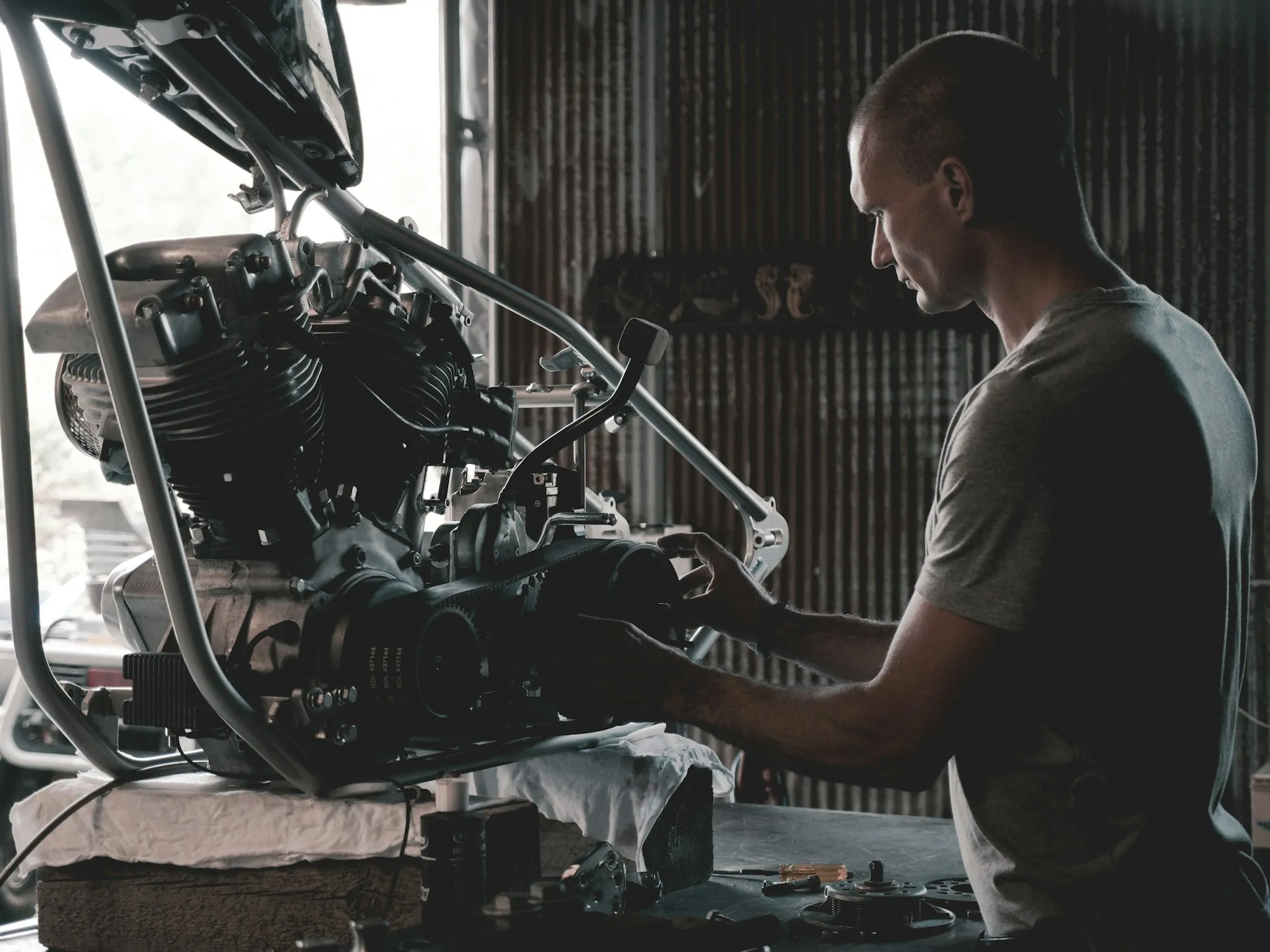 Mechanic leaning over an engine bay while working on a repair