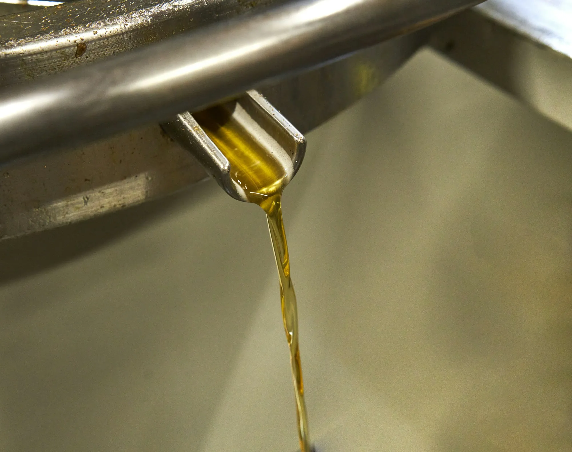 Fresh motor oil pouring into an engine
